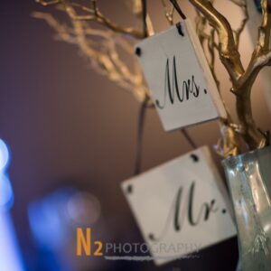 A gold tree with the words "Mr." and "Mrs." inside of a pale blue vase at Alegria Gardens Reception Hall in Houston.