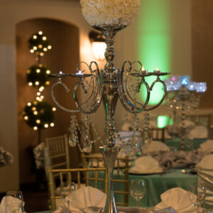 Metal flower bouquet on top of a dining table for a wedding reception at Alegria Gardens Reception Hall in Houston.