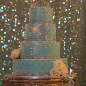 Blue quinceañera cake with a "15" at Alegria Gardens Reception Hall in Houston.