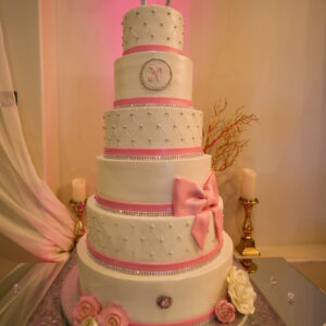 Wedding cake with pink ribbon at our wedding venue - Alegria Gardens