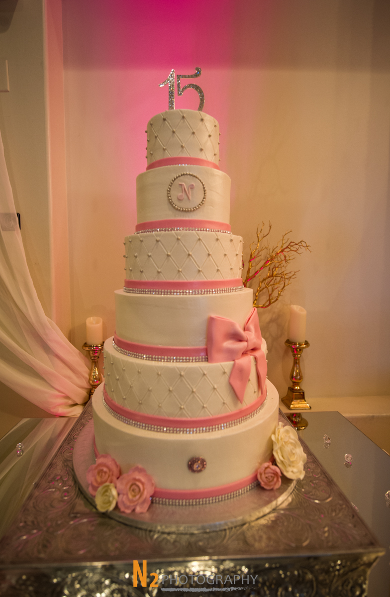 Wedding cake with pink ribbon at our wedding venue - Alegria Gardens