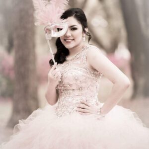 Girl in quinceanera dress and mask at our party hall - Alegria Gardens