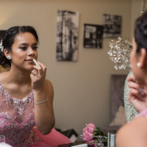 Party girl putting on makeup in mirror - Alegria Gardens