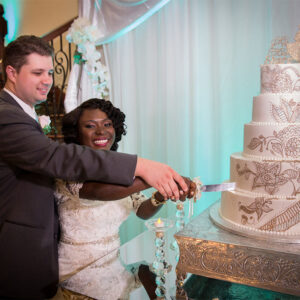 Couple cutting the cake at our reception hall - Alegria Gardens