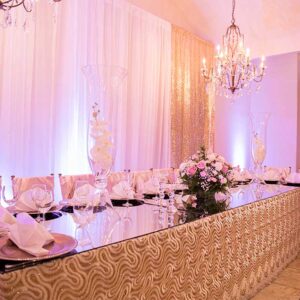 Wedding table with flowers and chandelier at our reception hall - Alegria Gardens