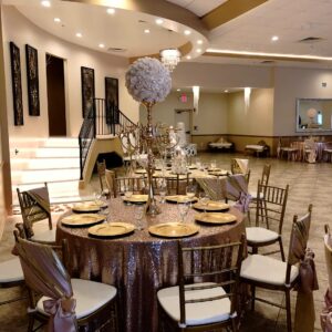 A picture of a decorated dining table inside Alegria Gardens Reception Hall at Stacy in Houston.