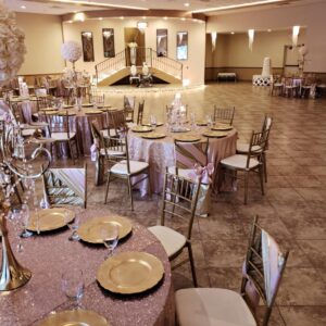 A picture featuring several decorated dining tables inside of Alegria Gardens Reception Hall at Stacy in Houston.