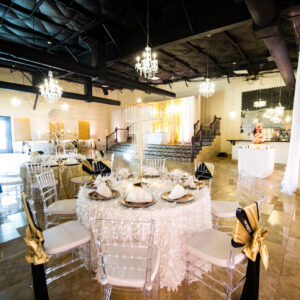 A photograph of decorated tables and chairs inside of the dining hall at Alegria Gardens at 529 in Houston.