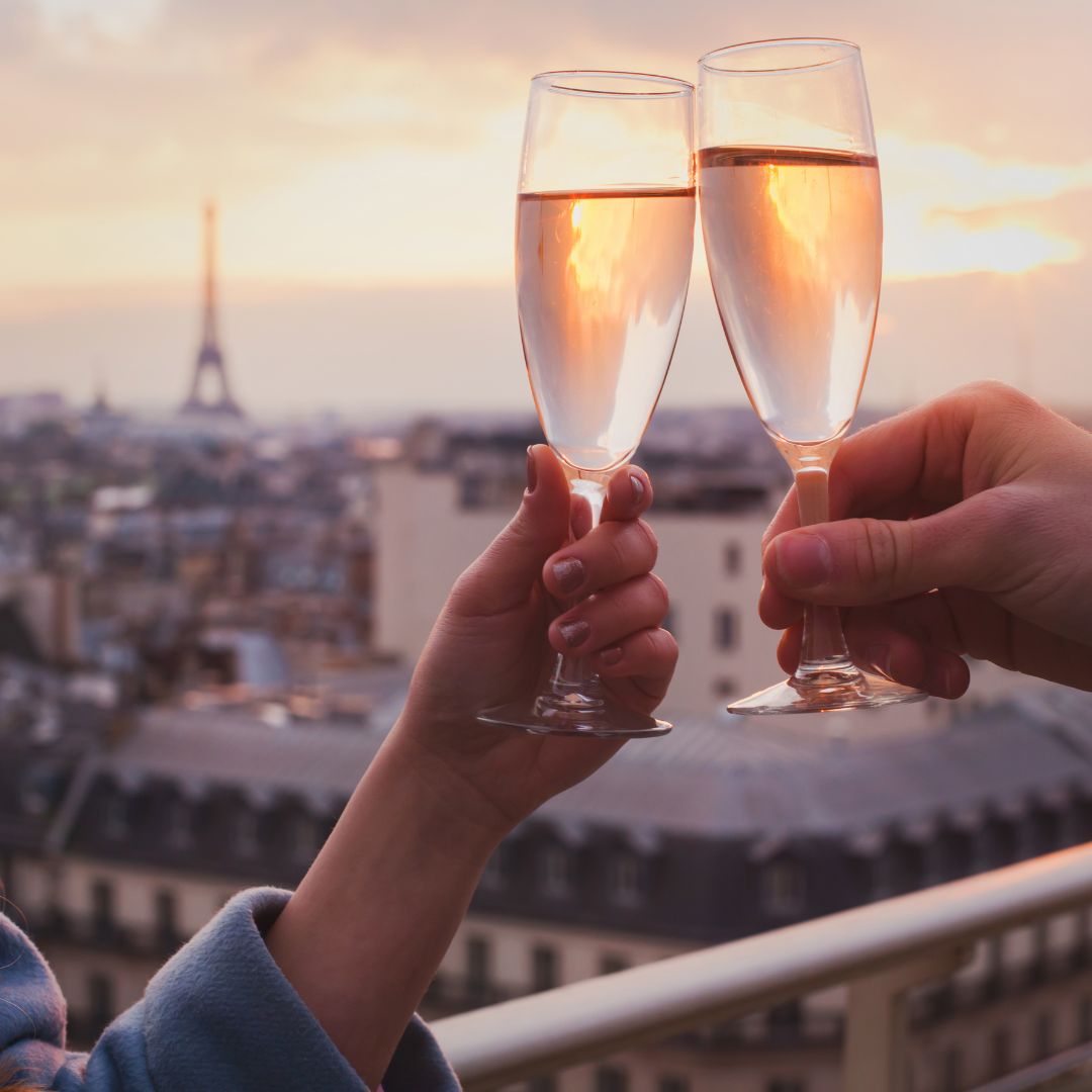clinking champagne glasses in Paris