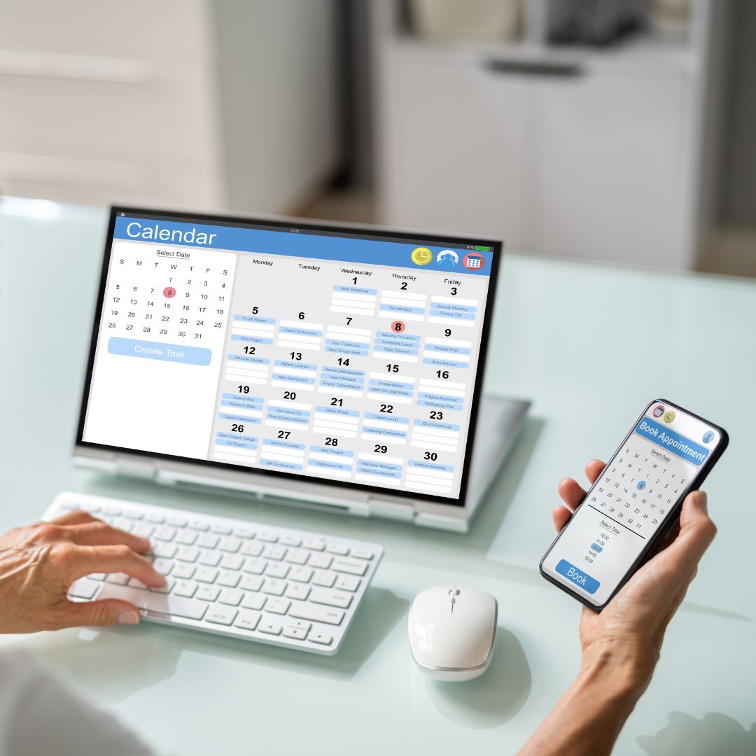 a person looking at a calendar on a computer and a cell phone