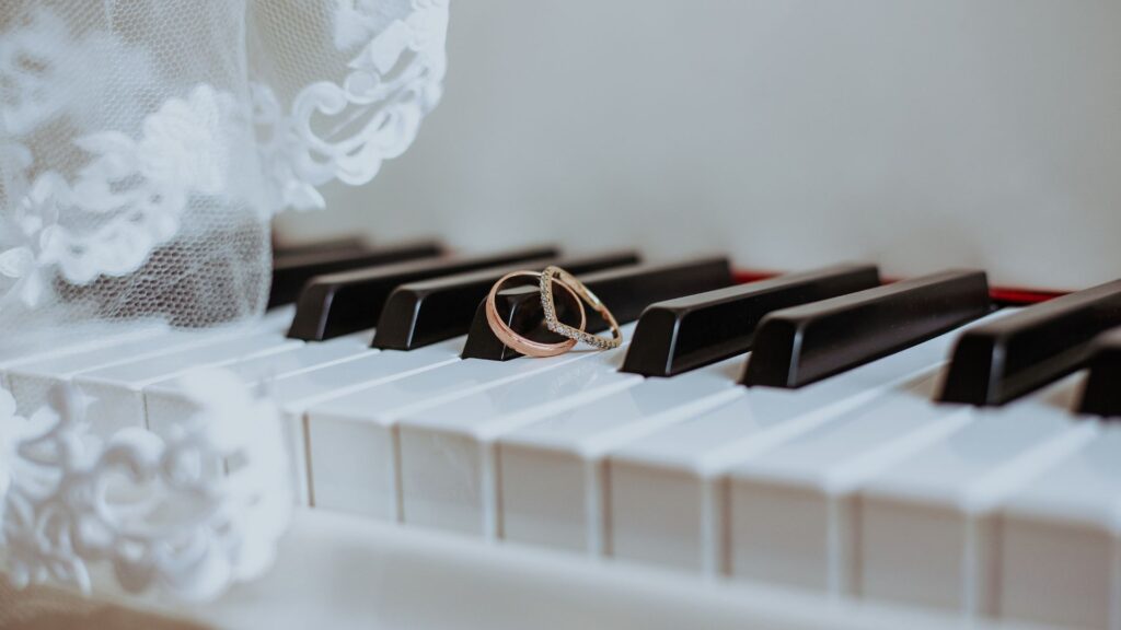 wedding rings on a piano